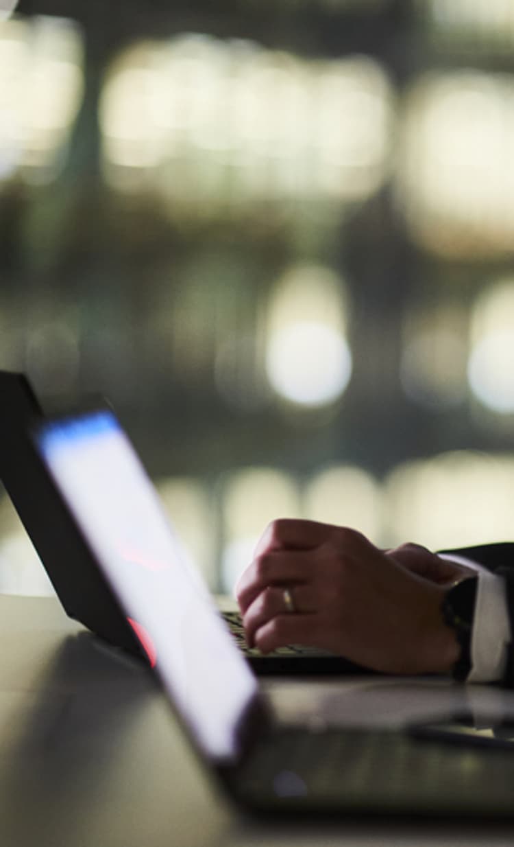 A person using a laptop at a desk, accessing Walkers Specialist Solutions for financial expertise.