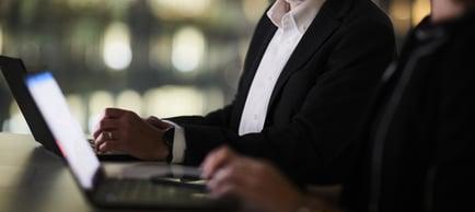 A person using a laptop at a desk, accessing Walkers Specialist Solutions for financial expertise.